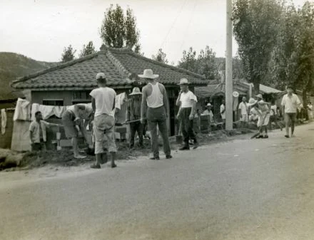 Neighbors by a tiled-roof house