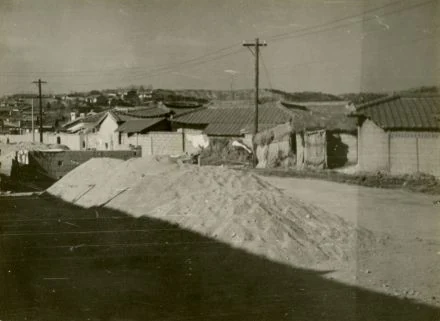 Low rooftops and an unpaved road