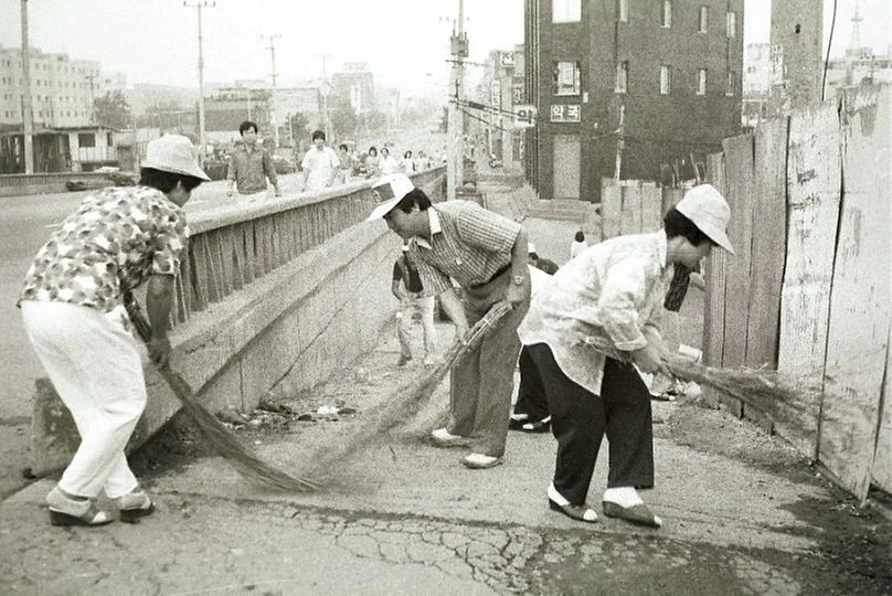 Sweeping a street after the flood