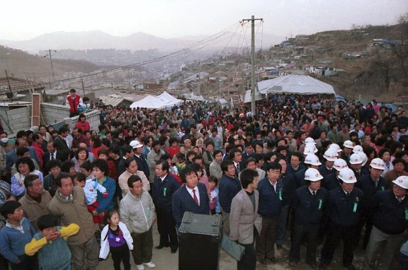 A gathering with the village behind